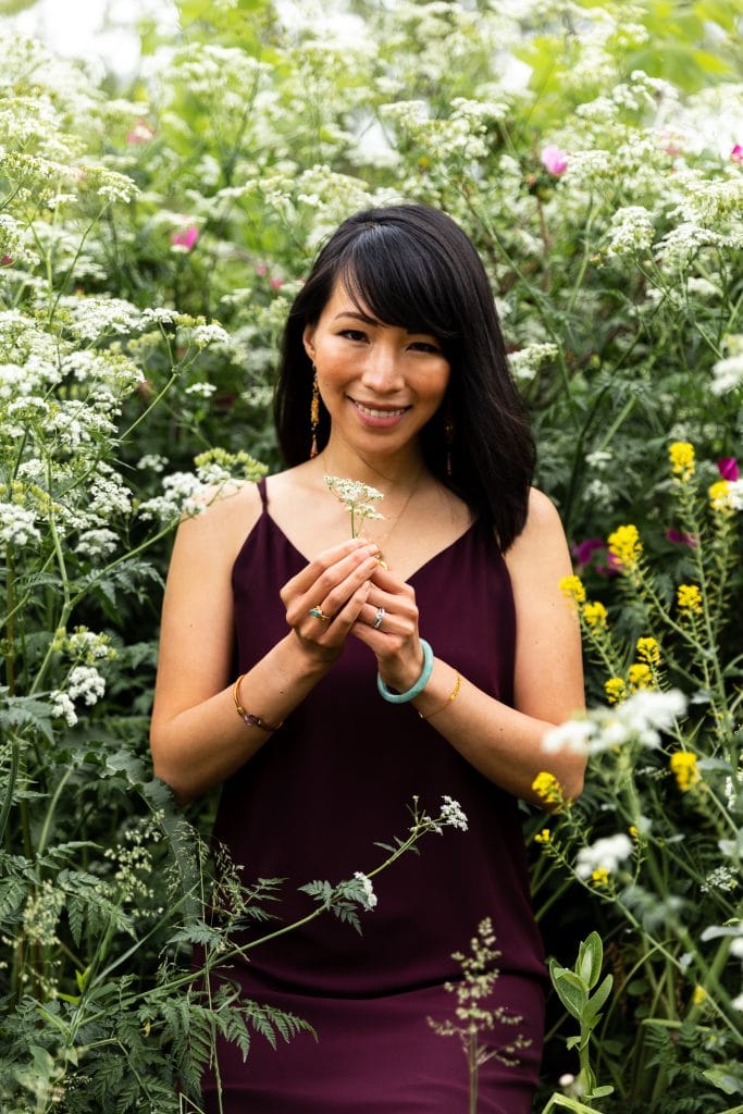 Julie Doan, holding flowers close to her face.